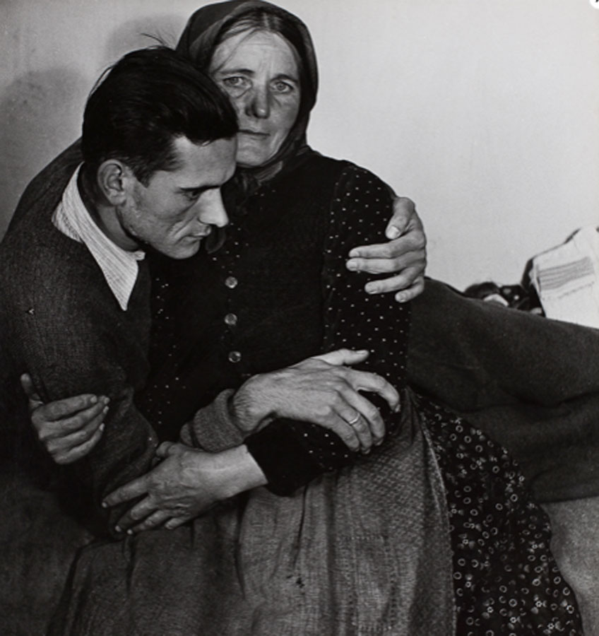 Madame d´Ora. Woman supporting a sickly man at a displaced persons camp in Austria, 1948
