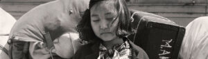 Dorothea Lange. Nisei girl with baggage, 1942. National Archives and Records Administration